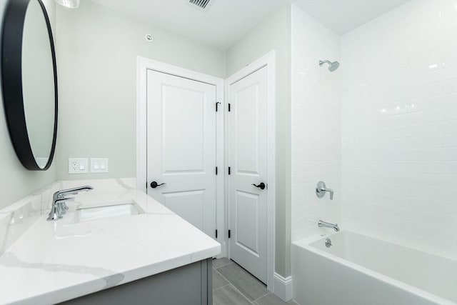 bathroom with vanity and tiled shower / bath combo