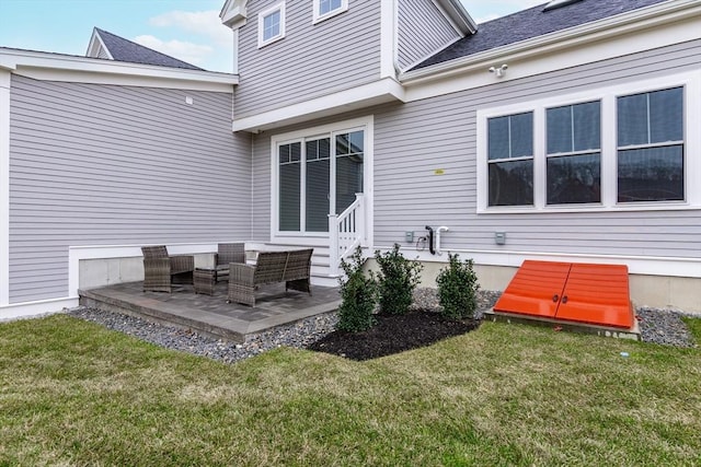 rear view of house featuring a patio area and a yard