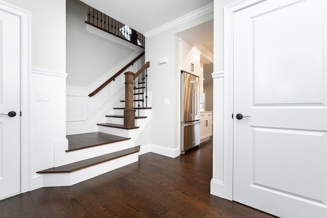 staircase featuring hardwood / wood-style floors and crown molding