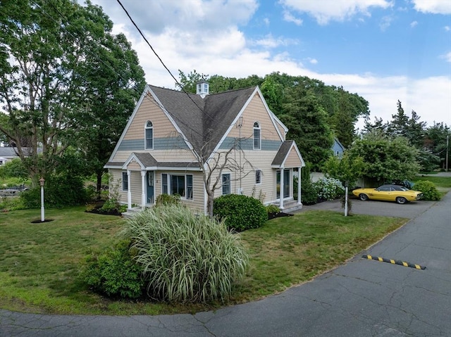 bungalow-style home featuring a front lawn