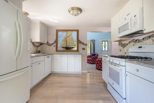 kitchen featuring tasteful backsplash, white cabinetry, and white appliances