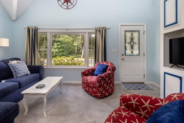 carpeted living room featuring vaulted ceiling