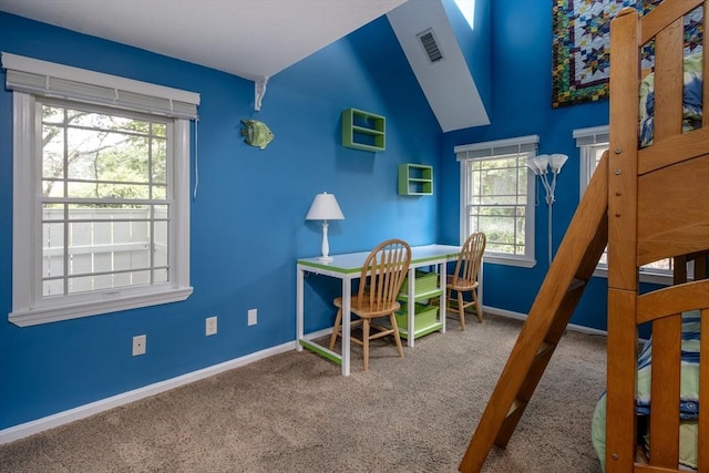 bedroom featuring multiple windows, lofted ceiling, and carpet floors