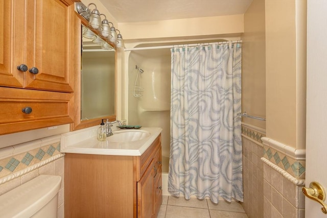 bathroom with tile walls, tile patterned flooring, a shower with curtain, and toilet