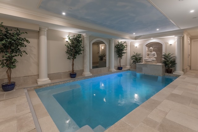 view of swimming pool with decorative columns and a hot tub