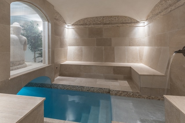 bathroom with tile walls