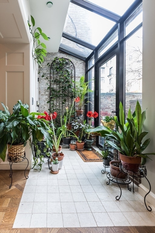 sunroom / solarium featuring lofted ceiling