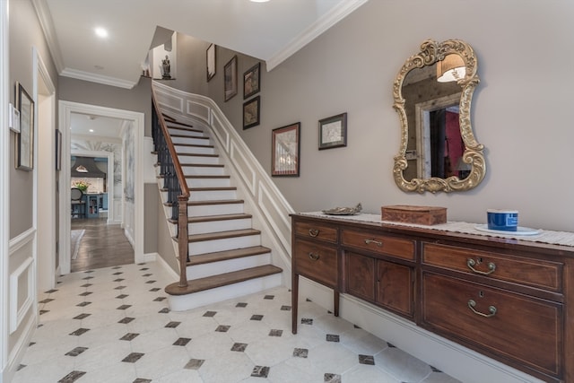 interior space featuring crown molding and light tile floors