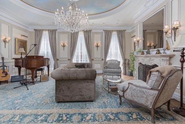 living room featuring crown molding, a chandelier, and a raised ceiling