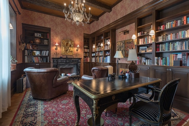 office featuring a fireplace, a notable chandelier, built in features, beam ceiling, and crown molding