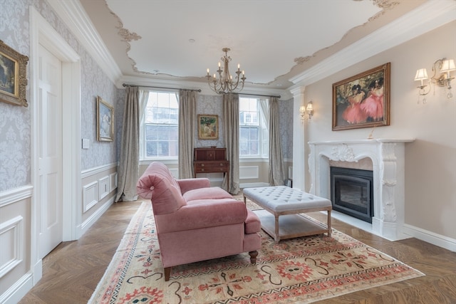 living area with a chandelier, crown molding, parquet floors, and a fireplace