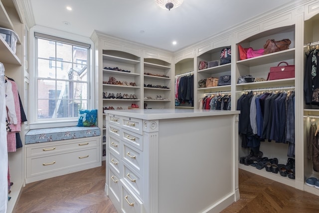 spacious closet with dark parquet flooring