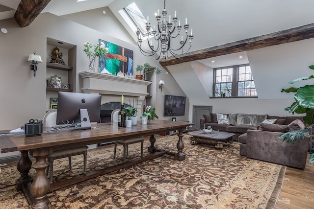 office area featuring light hardwood / wood-style flooring, a tile fireplace, a notable chandelier, and lofted ceiling with skylight