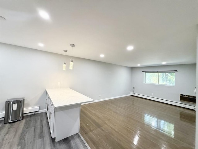 135 Granite Ave Unit 23, Boston, MA 02124 - basement with a baseboard radiator, dark wood-type flooring, recessed lighting, and baseboards