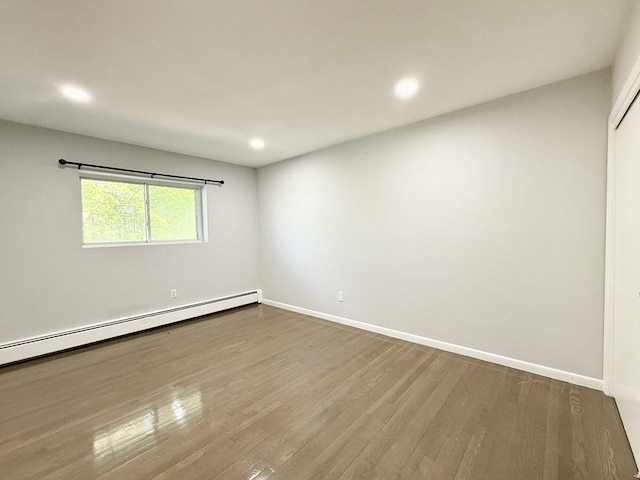 135 Granite Ave Unit 23, Boston, MA 02124 - unfurnished room with dark wood-style floors, a baseboard heating unit, baseboards, and recessed lighting