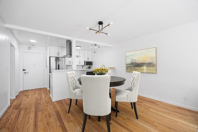 99 Pond Ave Unit 202, Brookline, MA 02445 - dining area with a chandelier and light wood-style flooring