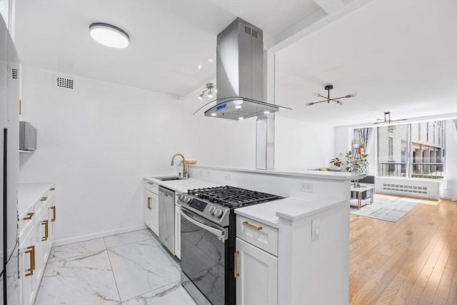 99 Pond Ave Unit 202, Brookline, MA 02445 - kitchen featuring appliances with stainless steel finishes, island range hood, a peninsula, light countertops, and white cabinetry