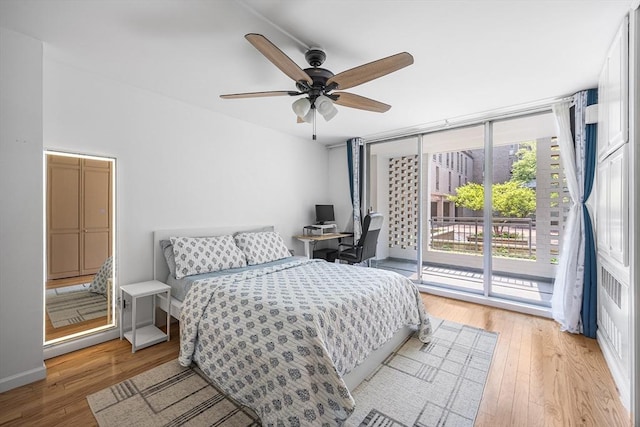 99 Pond Ave Unit 202, Brookline, MA 02445 - bedroom with access to exterior, light wood-style flooring, a ceiling fan, and an office area