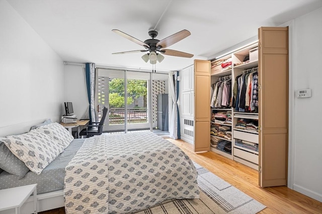 99 Pond Ave Unit 202, Brookline, MA 02445 - bedroom with access to outside, light wood-type flooring, floor to ceiling windows, and ceiling fan