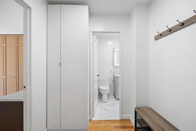 99 Pond Ave Unit 202, Brookline, MA 02445 - bathroom with toilet and marble look tile flooring