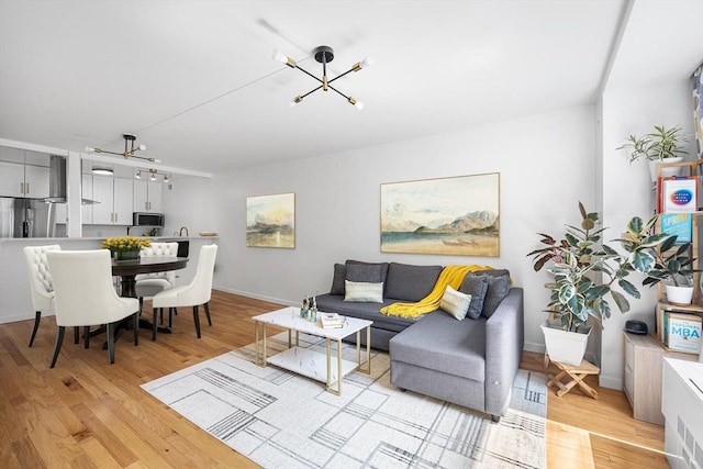 99 Pond Ave Unit 202, Brookline, MA 02445 - living room with a chandelier and light wood finished floors