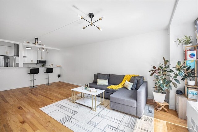 99 Pond Ave Unit 202, Brookline, MA 02445 - living area with a chandelier and light wood-type flooring