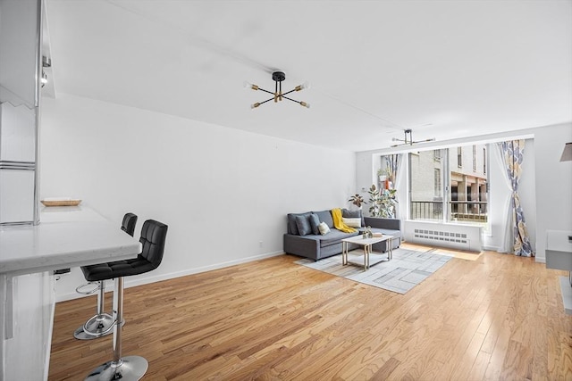 99 Pond Ave Unit 202, Brookline, MA 02445 - office area with light wood-style floors, radiator, and a chandelier