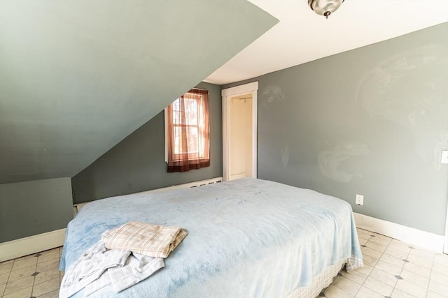 bedroom featuring lofted ceiling