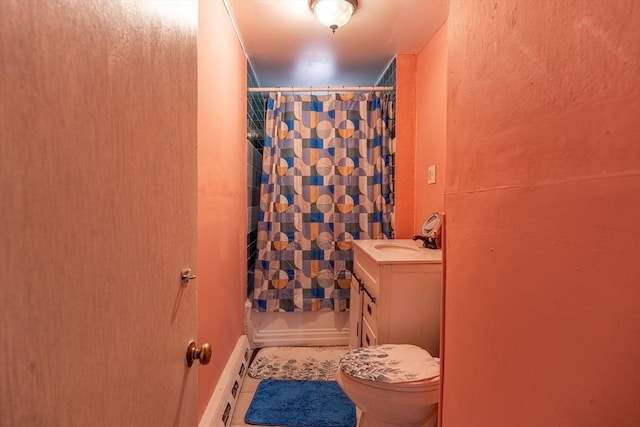 bathroom featuring vanity, a baseboard heating unit, tile patterned flooring, and toilet