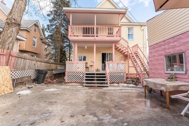 rear view of house with a balcony and a patio area