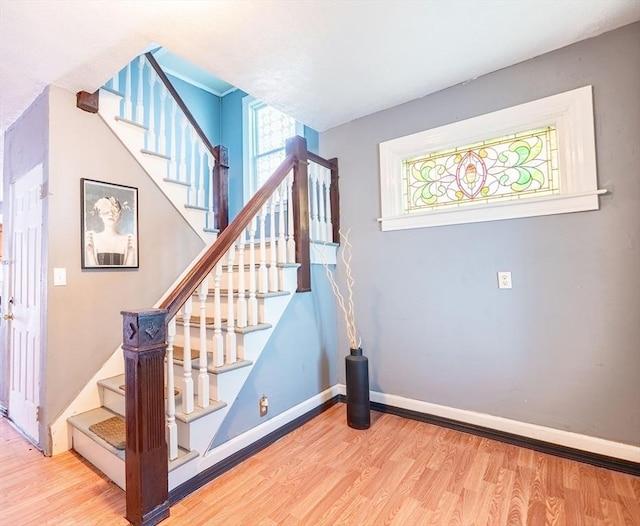 stairway with hardwood / wood-style floors