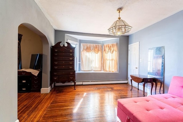 living area featuring dark hardwood / wood-style floors and an inviting chandelier