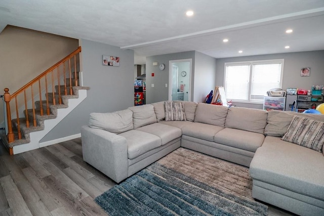 living room featuring stairs, baseboards, recessed lighting, and wood finished floors