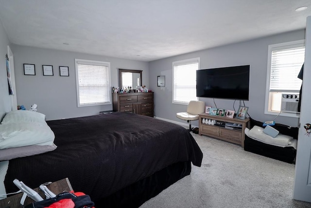 carpeted bedroom with baseboards and cooling unit