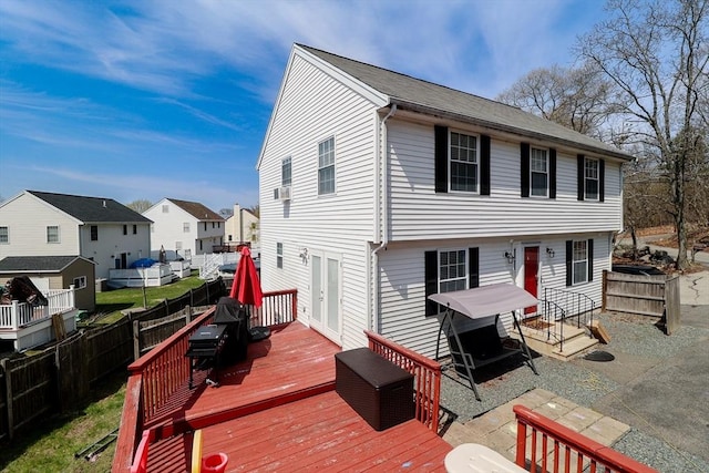 exterior space with a patio area, a wooden deck, a residential view, and a fenced backyard