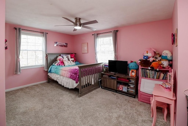 bedroom featuring light carpet, baseboards, a ceiling fan, and multiple windows