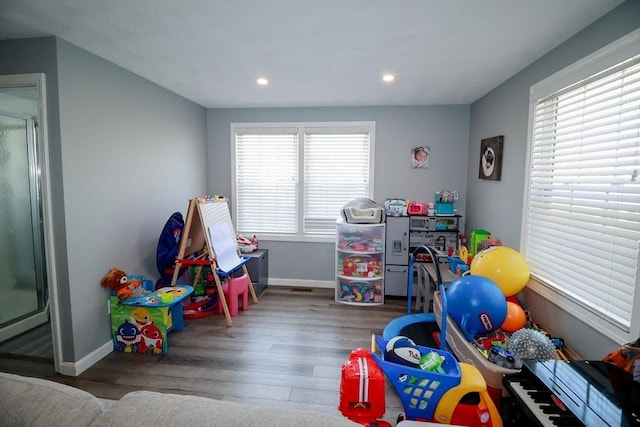 recreation room featuring baseboards, recessed lighting, and wood finished floors