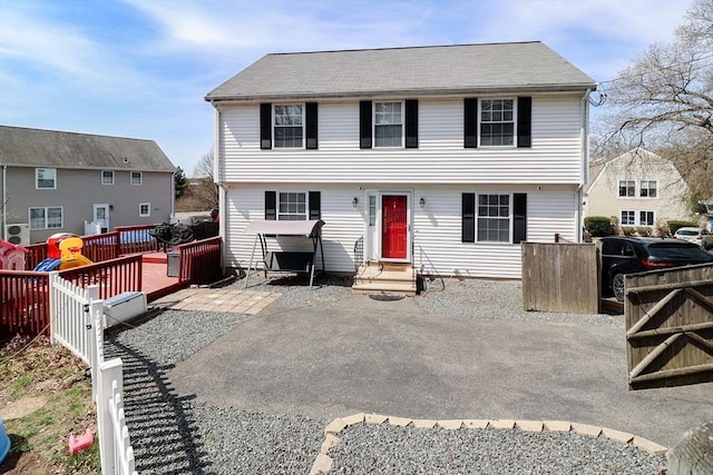 colonial house with fence and entry steps