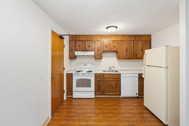 kitchen with white appliances, tasteful backsplash, dark wood-type flooring, and sink