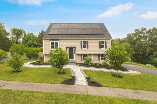 1 Cherry Tree Ln, Plainville, MA 02762 - view of front of home with curved driveway, roof mounted solar panels, a front lawn, and roof with shingles