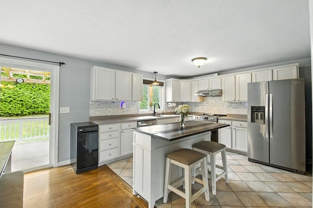 1 Cherry Tree Ln, Plainville, MA 02762 - kitchen with stainless steel appliances, under cabinet range hood, backsplash, and white cabinets
