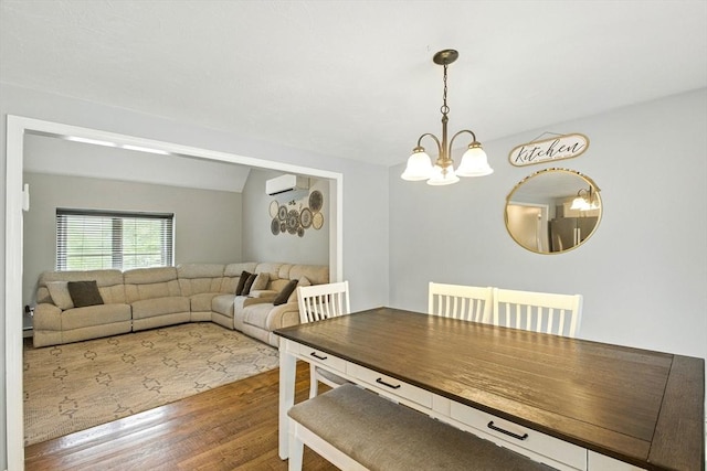 1 Cherry Tree Ln, Plainville, MA 02762 - dining space featuring wood finished floors, a chandelier, and a wall mounted air conditioner