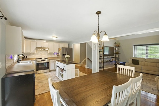 1 Cherry Tree Ln, Plainville, MA 02762 - dining area with stairway and a chandelier
