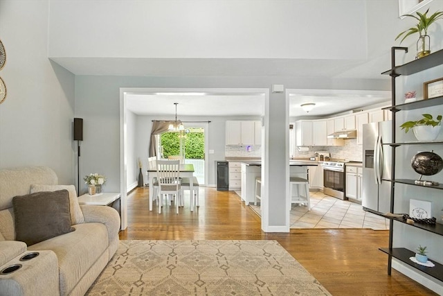 1 Cherry Tree Ln, Plainville, MA 02762 - living area with light wood-type flooring and a chandelier