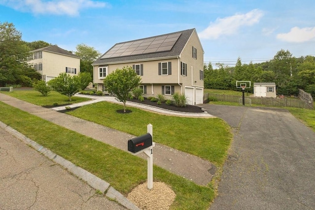 1 Cherry Tree Ln, Plainville, MA 02762 - view of front of home with roof mounted solar panels, an attached garage, and driveway