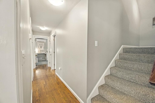 1 Cherry Tree Ln, Plainville, MA 02762 - corridor featuring wood finished floors, stairway, and a wall mounted air conditioner