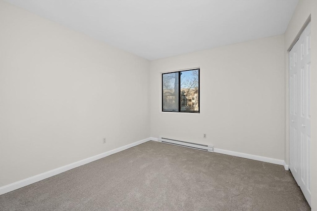 unfurnished bedroom with carpet flooring, a closet, and a baseboard heating unit