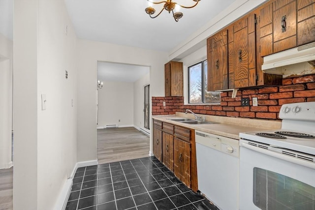 kitchen with baseboard heating, sink, white appliances, and a notable chandelier