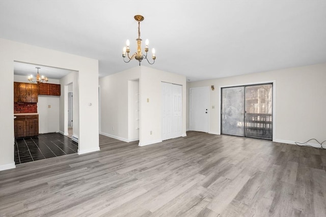 unfurnished living room featuring hardwood / wood-style flooring and a notable chandelier