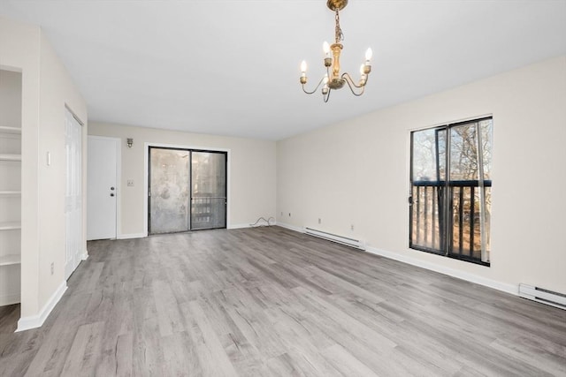 unfurnished room with a notable chandelier, light hardwood / wood-style flooring, and a baseboard radiator